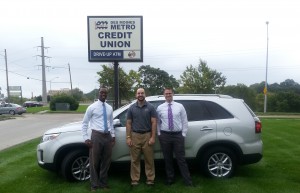 three men with SUV